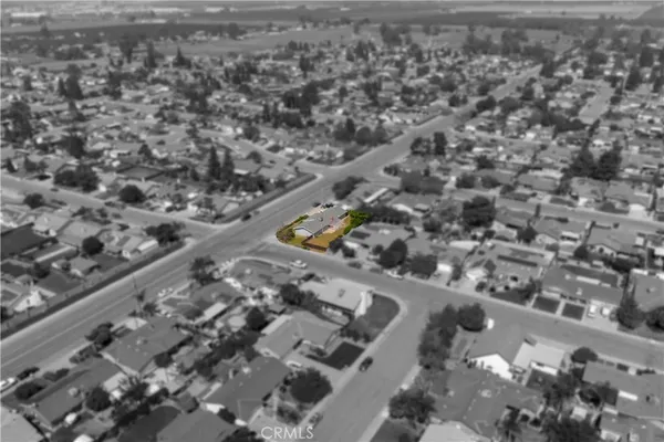 an aerial view of a house with a yard and lake view