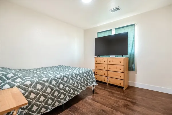 a bedroom with a bed and flat screen tv