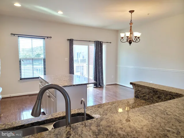 a view of a livingroom with a piano and wooden floor