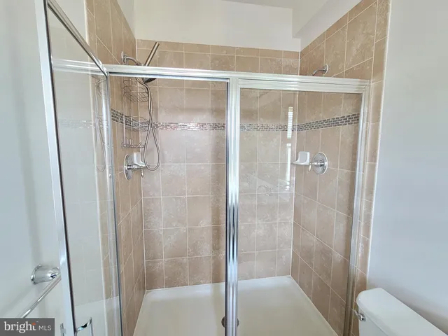 a bathroom with a glass shower door