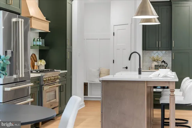 a kitchen with a sink cabinets and appliances