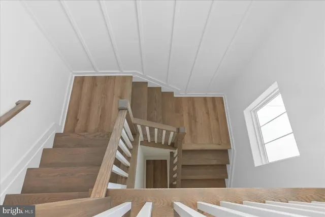 a view of staircase with wooden floor and window