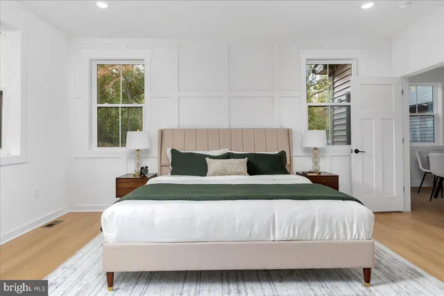 a bedroom with a bed and wooden floor