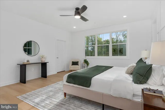 a bedroom with a bed a mirror and window