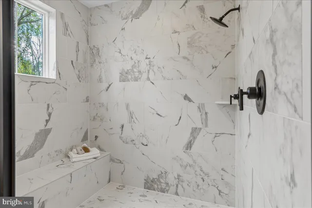 a bathroom with a bathtub and shower