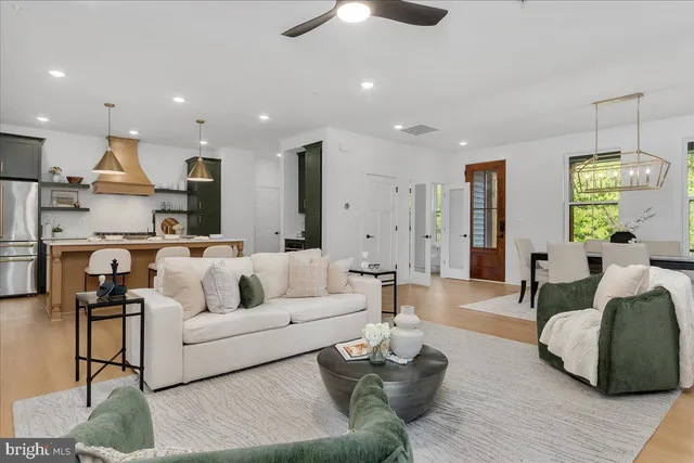 a living room with furniture and a chandelier
