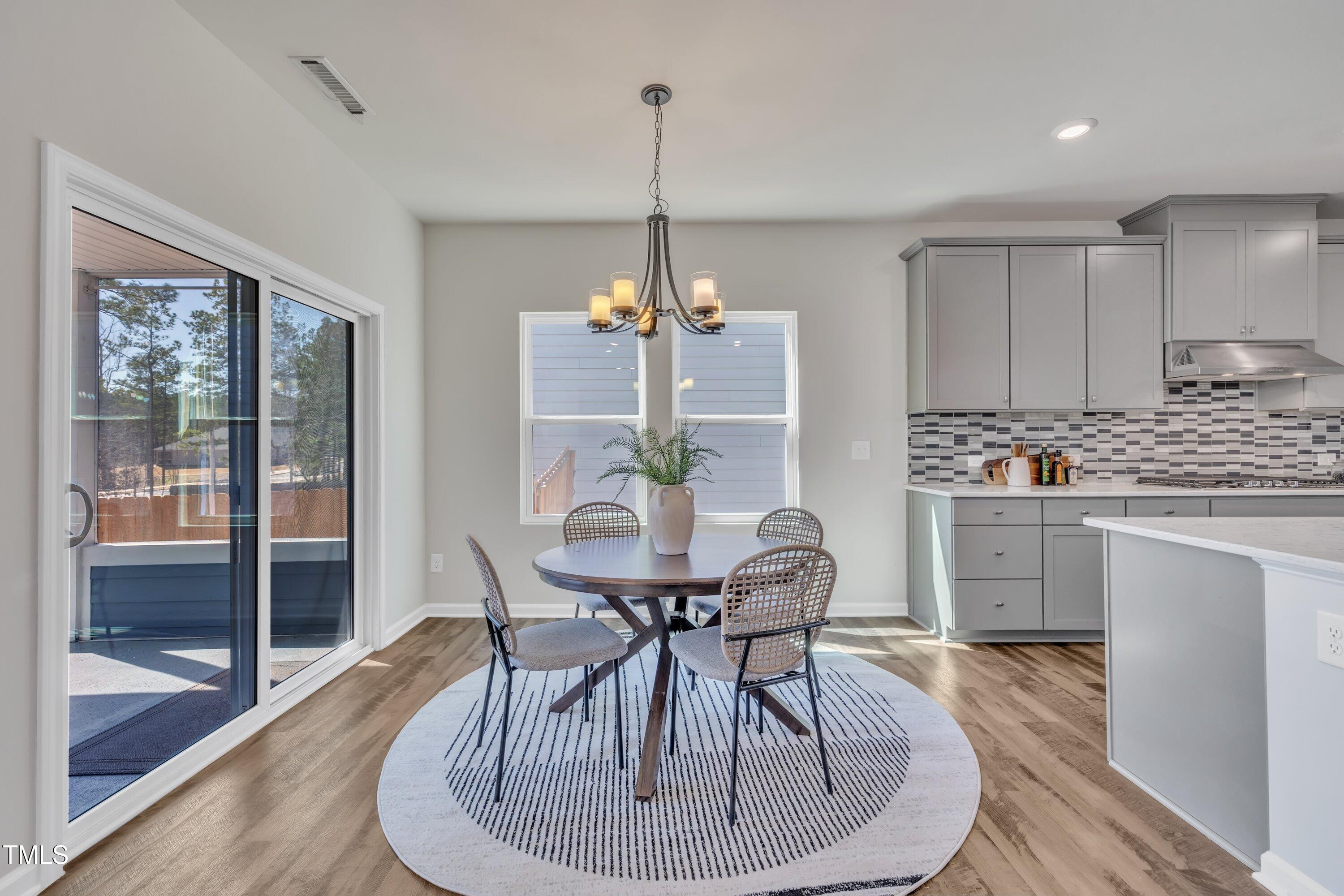 3381 Lovage Drive Apex, NC 27502 - Photo 19 of 50 a dining room with furniture and window