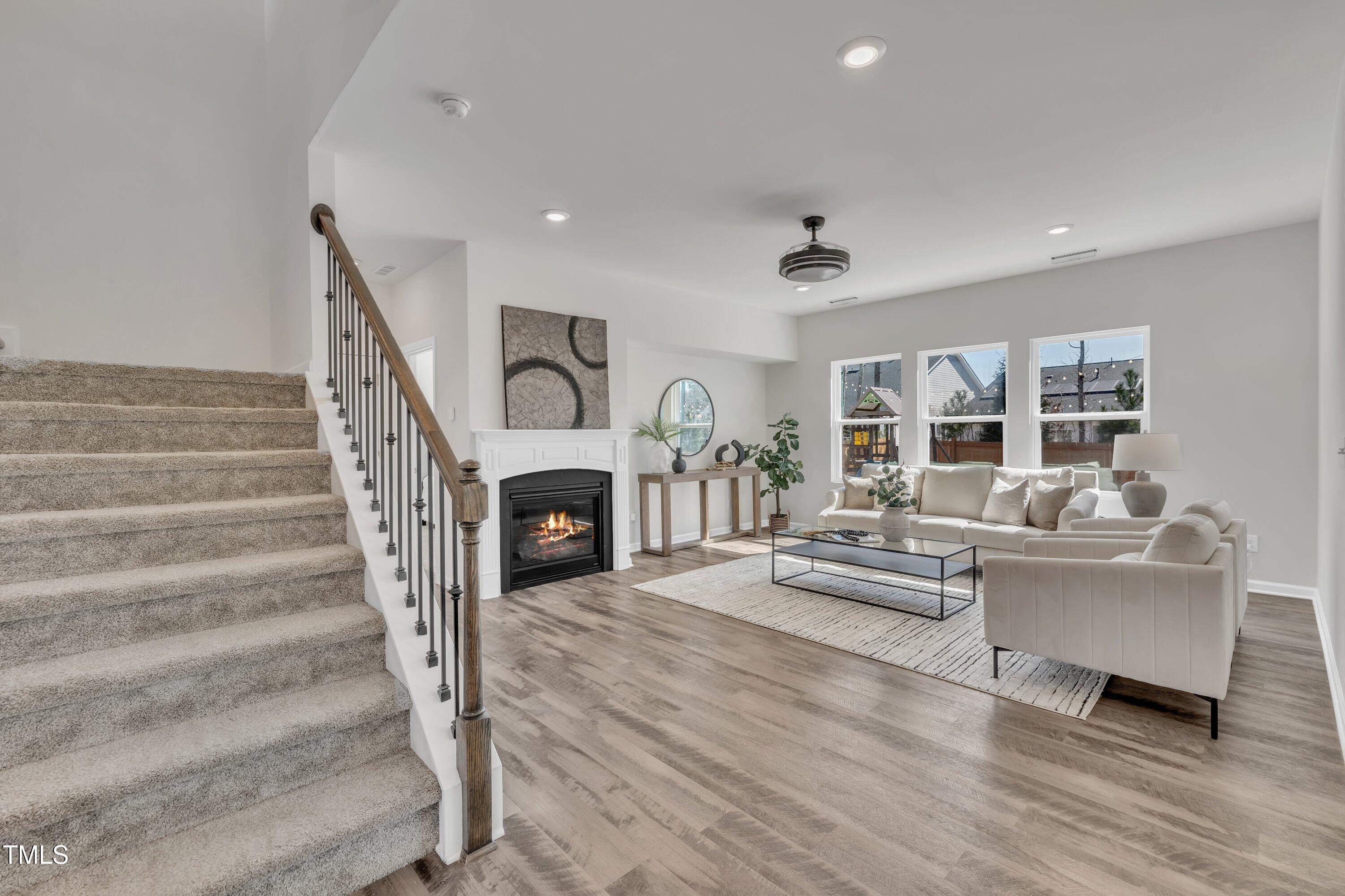 3381 Lovage Drive Apex, NC 27502 - Photo 20 of 50 a living room with fireplace furniture and a wooden floor