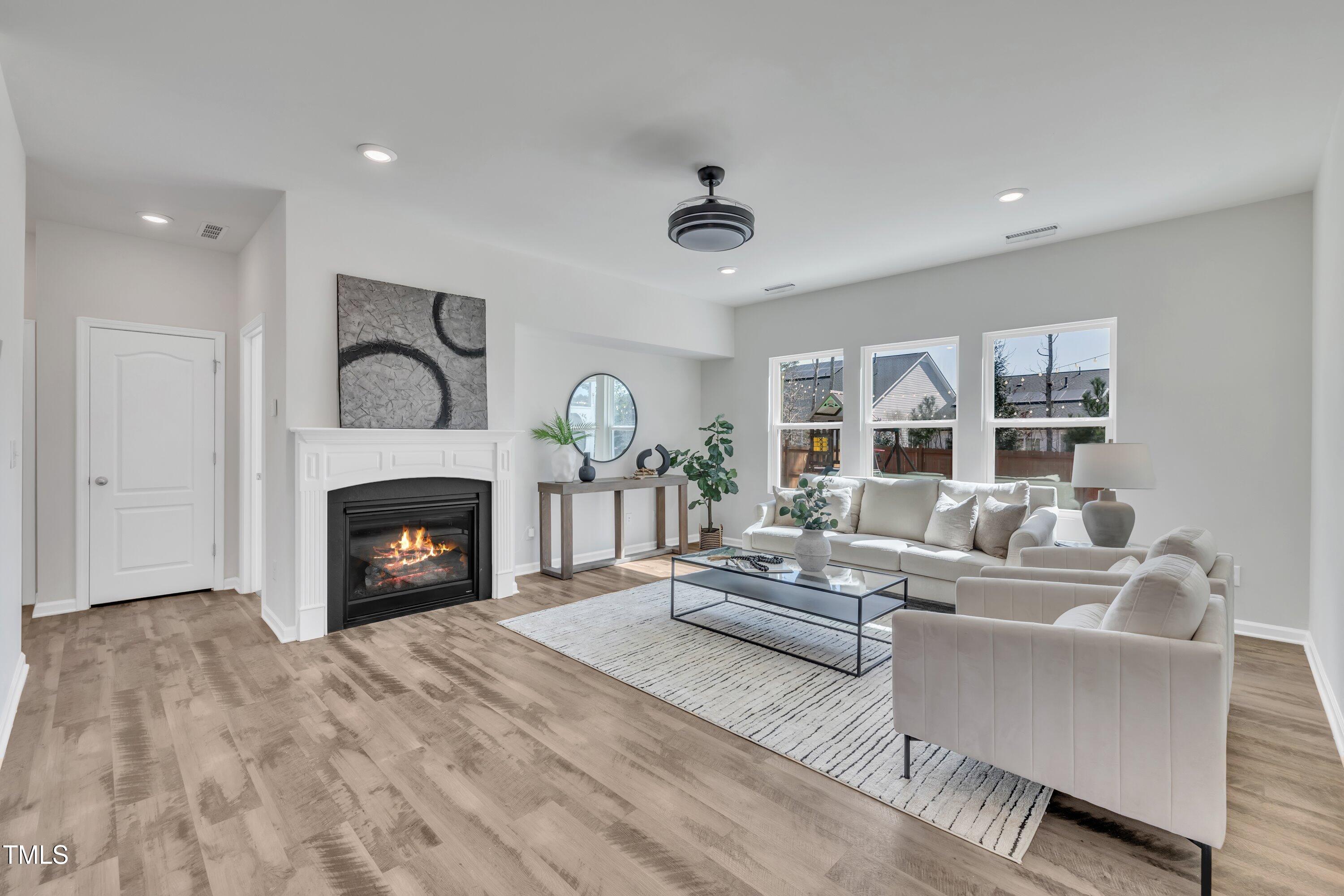 3381 Lovage Drive Apex, NC 27502 - Photo 21 of 50 a living room with furniture and a fireplace