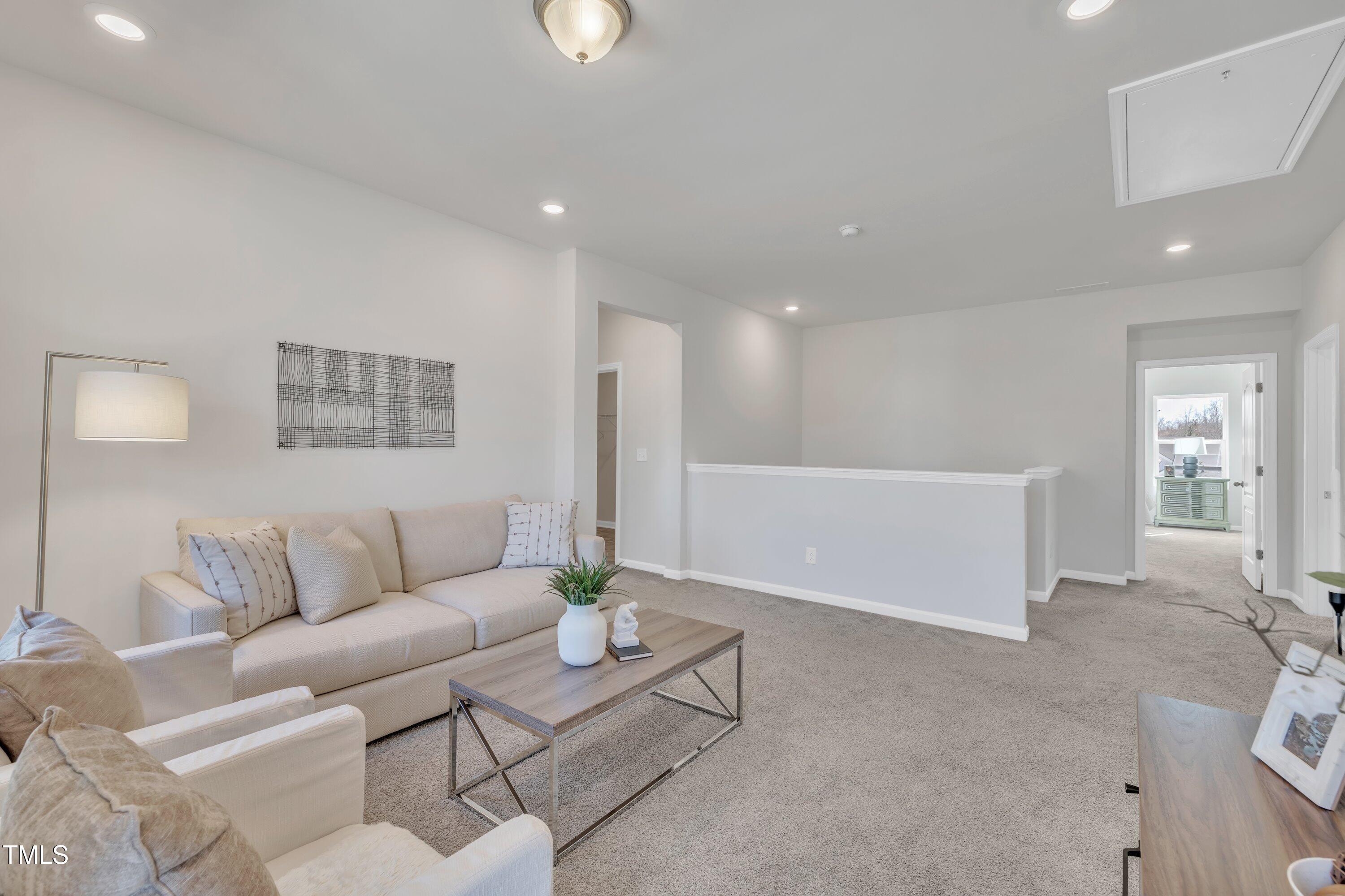 3381 Lovage Drive Apex, NC 27502 - Photo 30 of 50 a living room with furniture and a couch