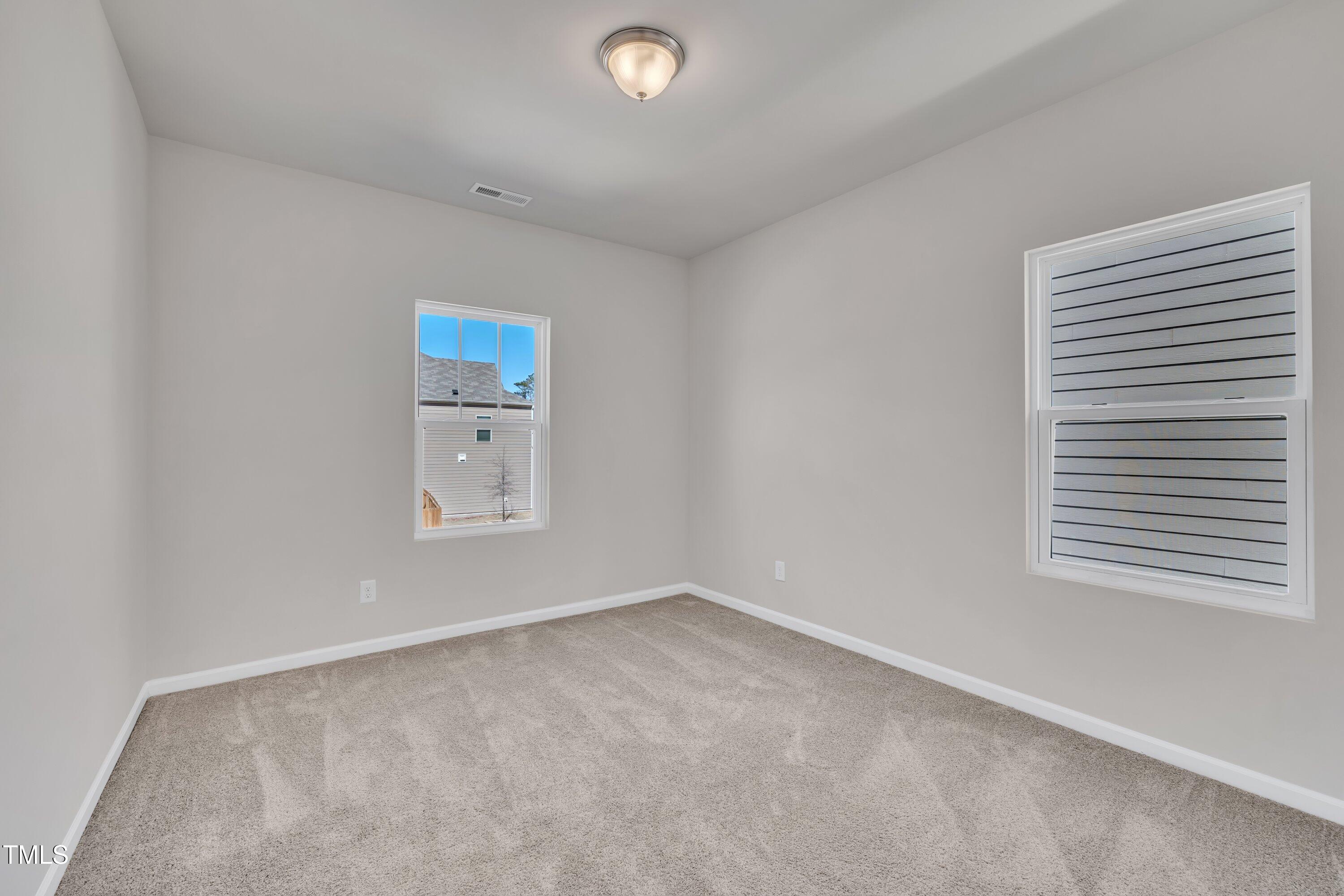 3381 Lovage Drive Apex, NC 27502 - Photo 32 of 50 an empty room with windows