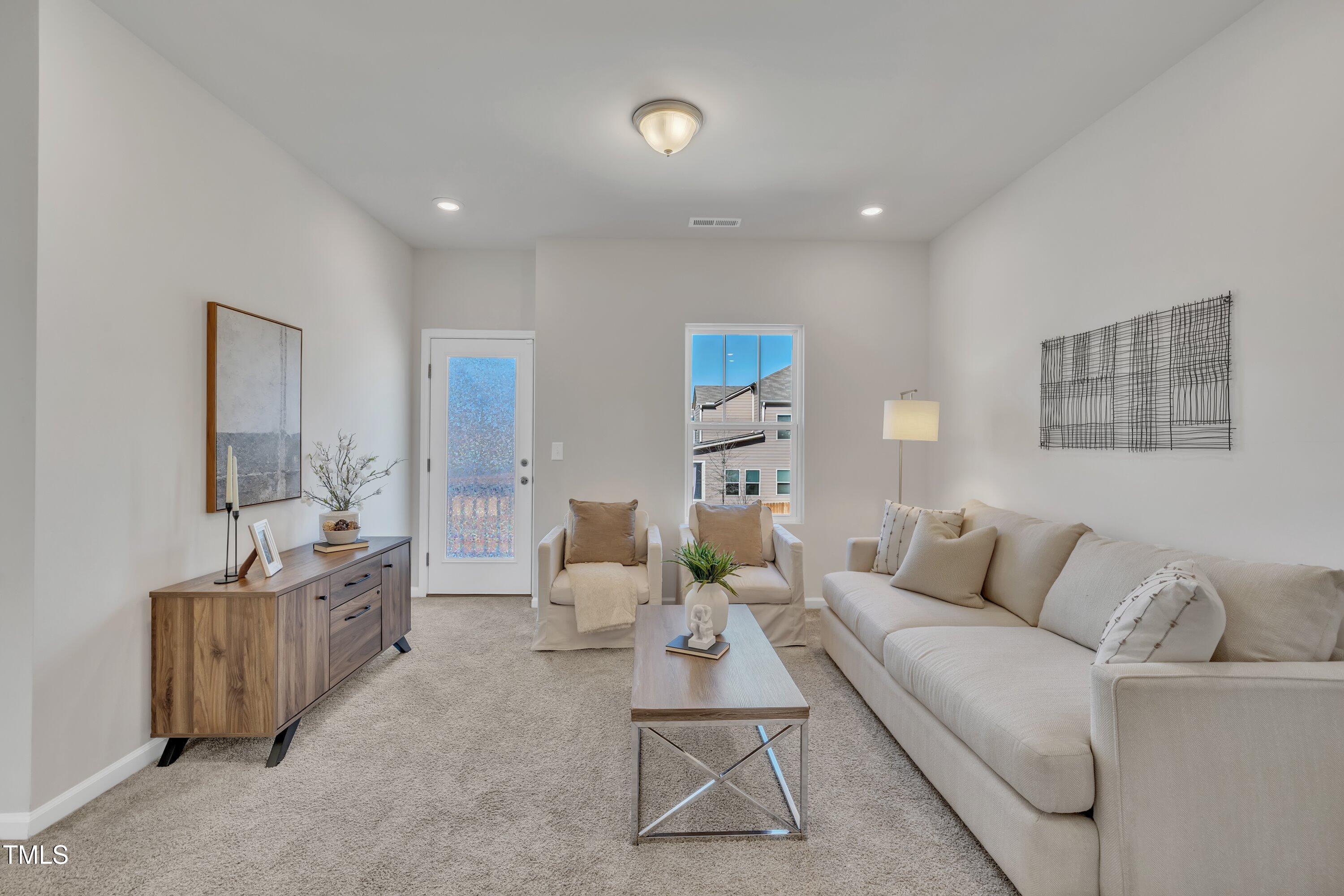 3381 Lovage Drive Apex, NC 27502 - Photo 34 of 50 a living room with furniture and a table