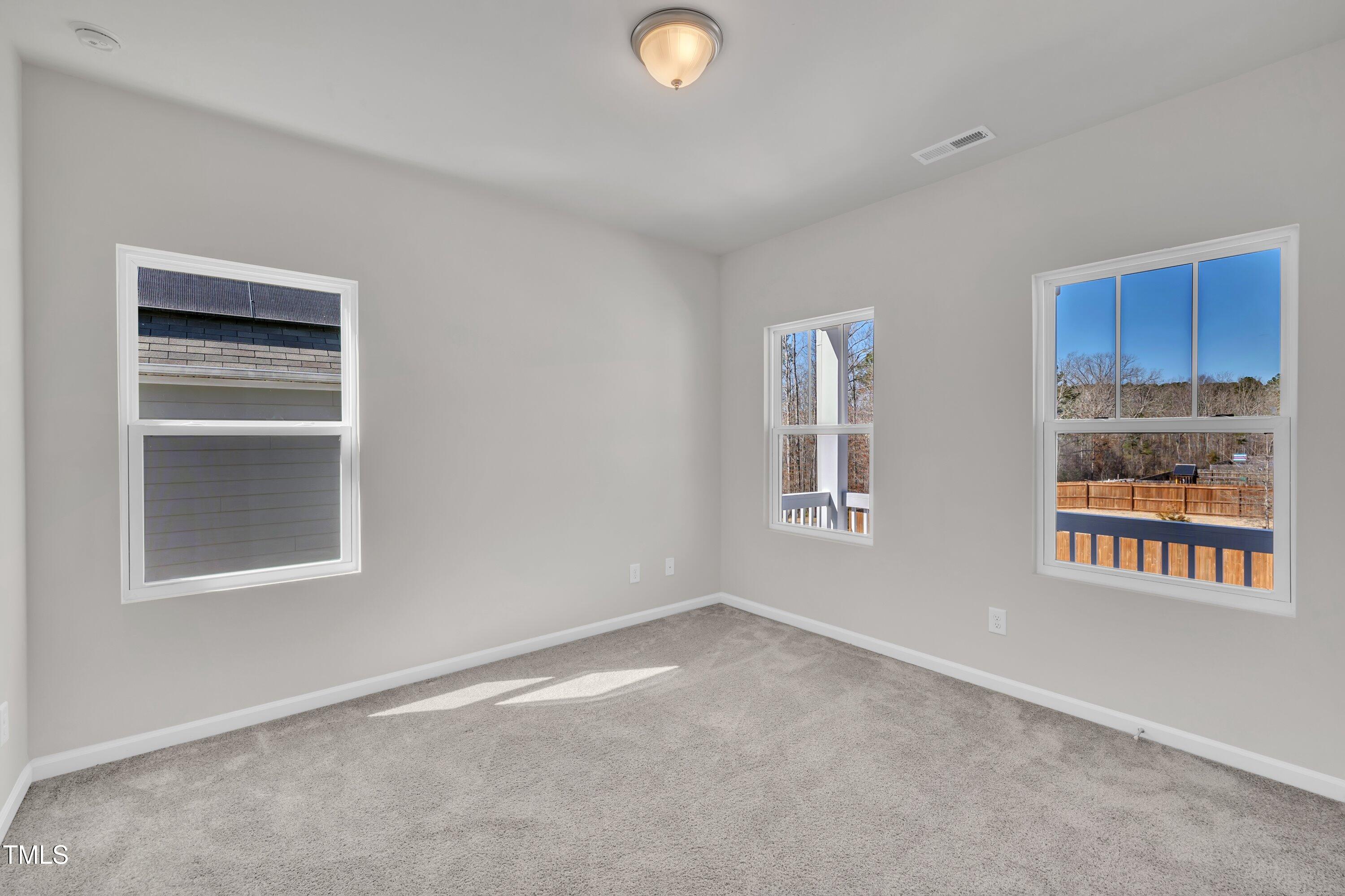 3381 Lovage Drive Apex, NC 27502 - Photo 35 of 50 a view of an empty room with window and cabinet