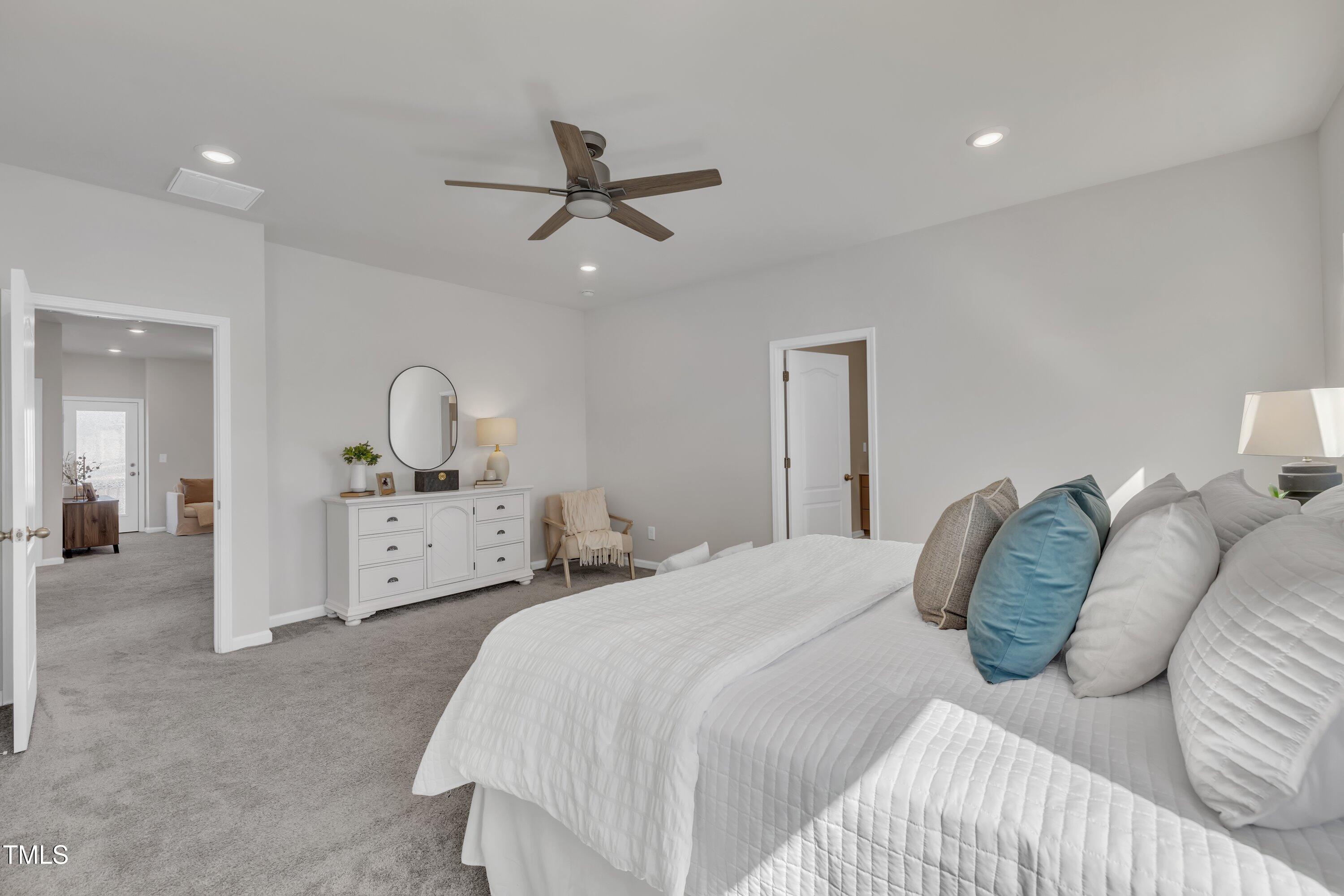 3381 Lovage Drive Apex, NC 27502 - Photo 41 of 50 a bedroom with a bed and ceiling fan