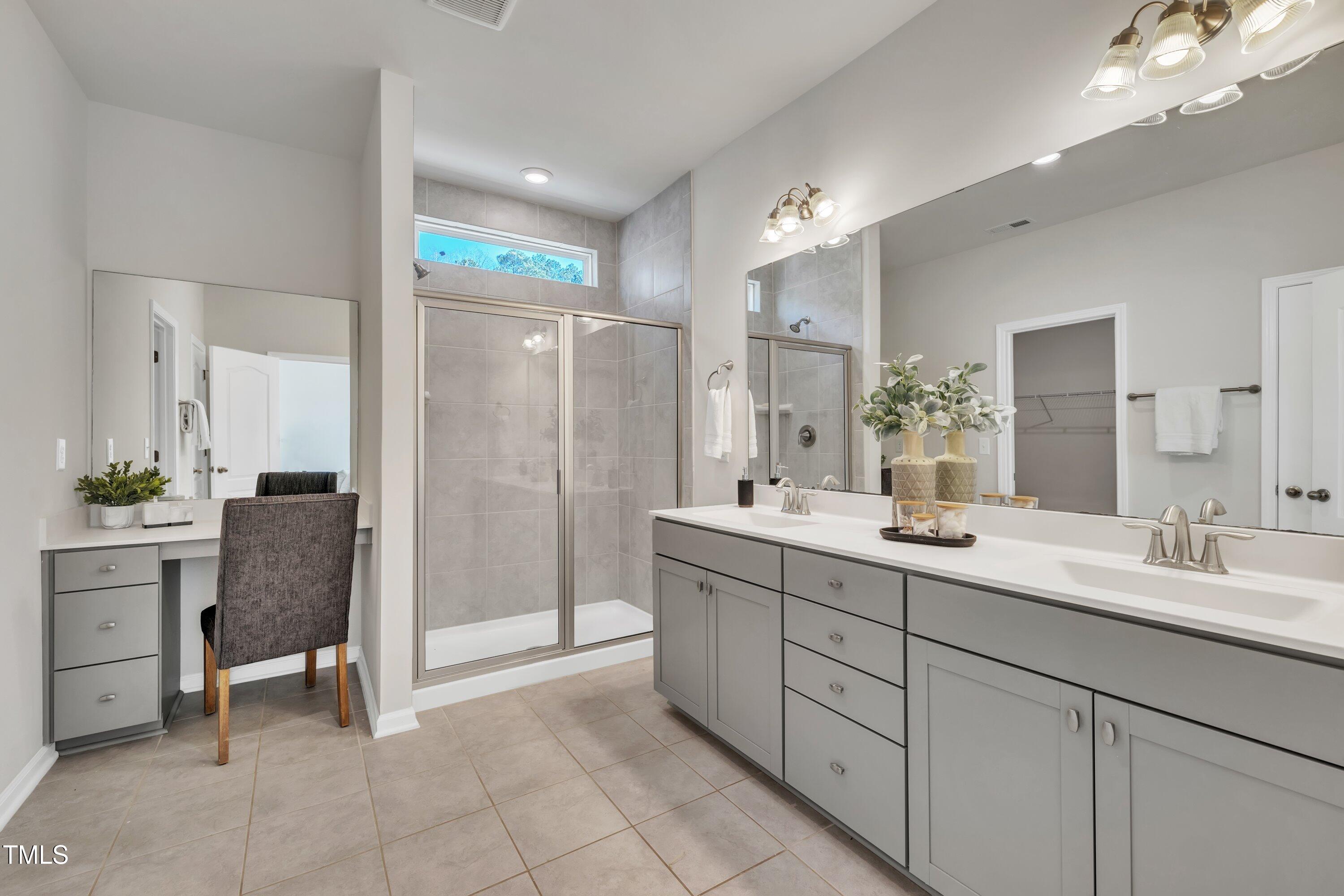 3381 Lovage Drive Apex, NC 27502 - Photo 43 of 50 a bathroom with a double vanity sink and a mirror