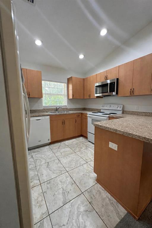 6800 Northeast 175th Street Road Citra, FL 32113 - Photo 10 of 27 a kitchen with stainless steel appliances granite countertop a sink and a stove top oven