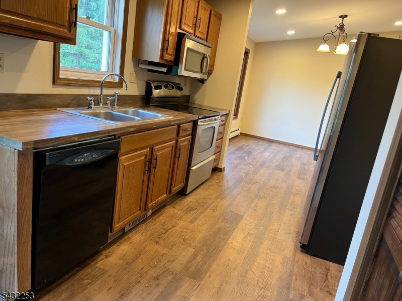 31 Countryside Road Columbia, NJ 07832 - Photo 24 of 31 a kitchen with stainless steel appliances granite countertop a sink stove and refrigerator