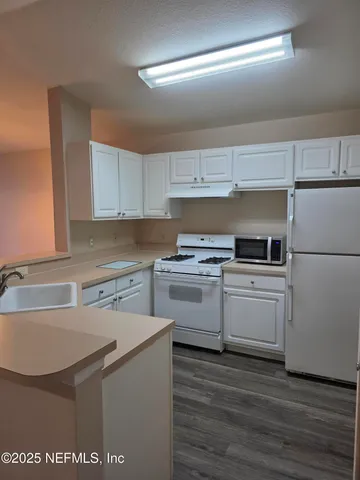 a kitchen with a sink cabinets and stainless steel appliances