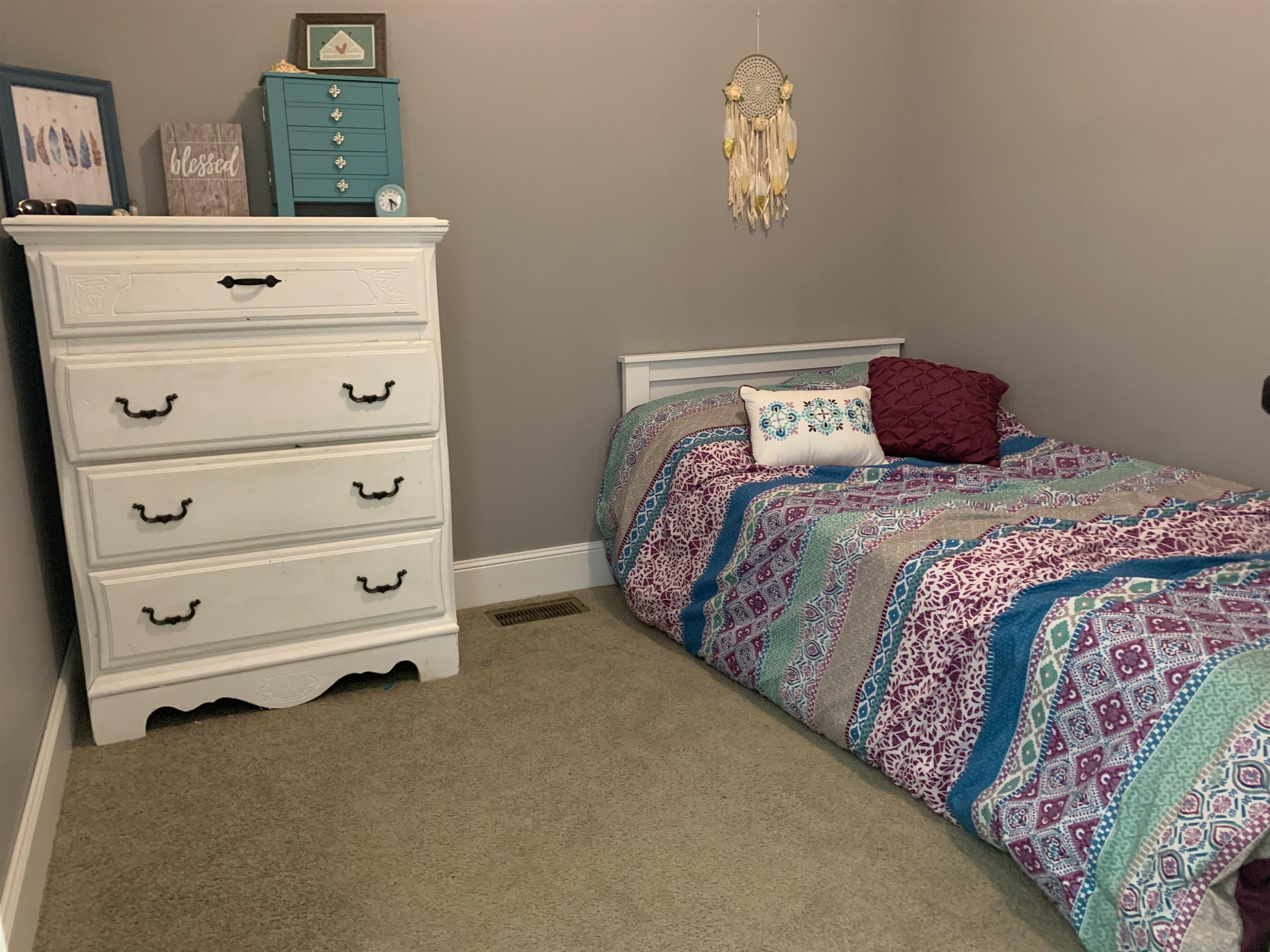 3070 Westport Road Huntingdon, TN 38344 - Photo 15 of 23 a bedroom with a bed and a dresser