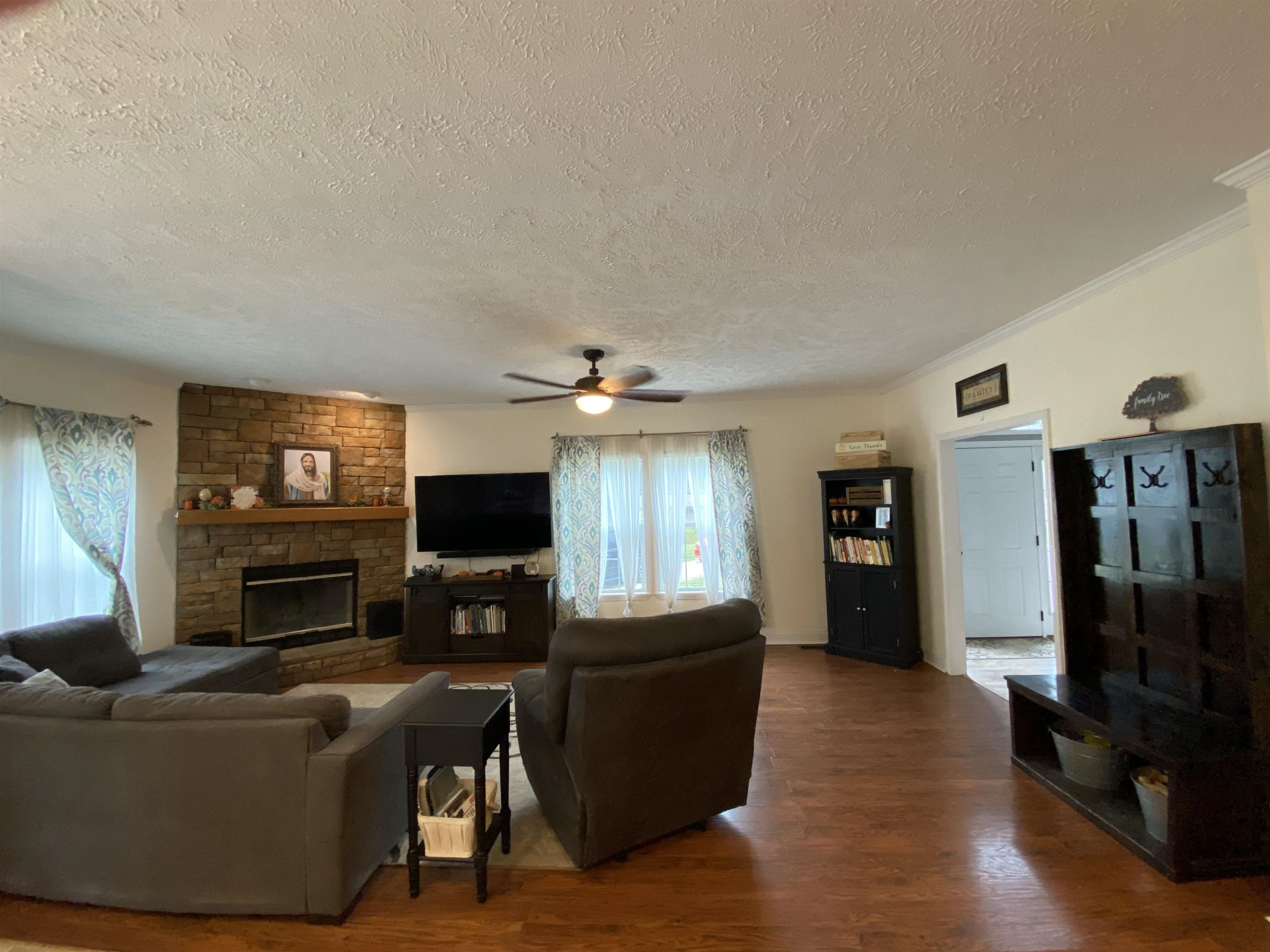 3070 Westport Road Huntingdon, TN 38344 - Photo 4 of 23 a living room with furniture a flat screen tv and a fireplace