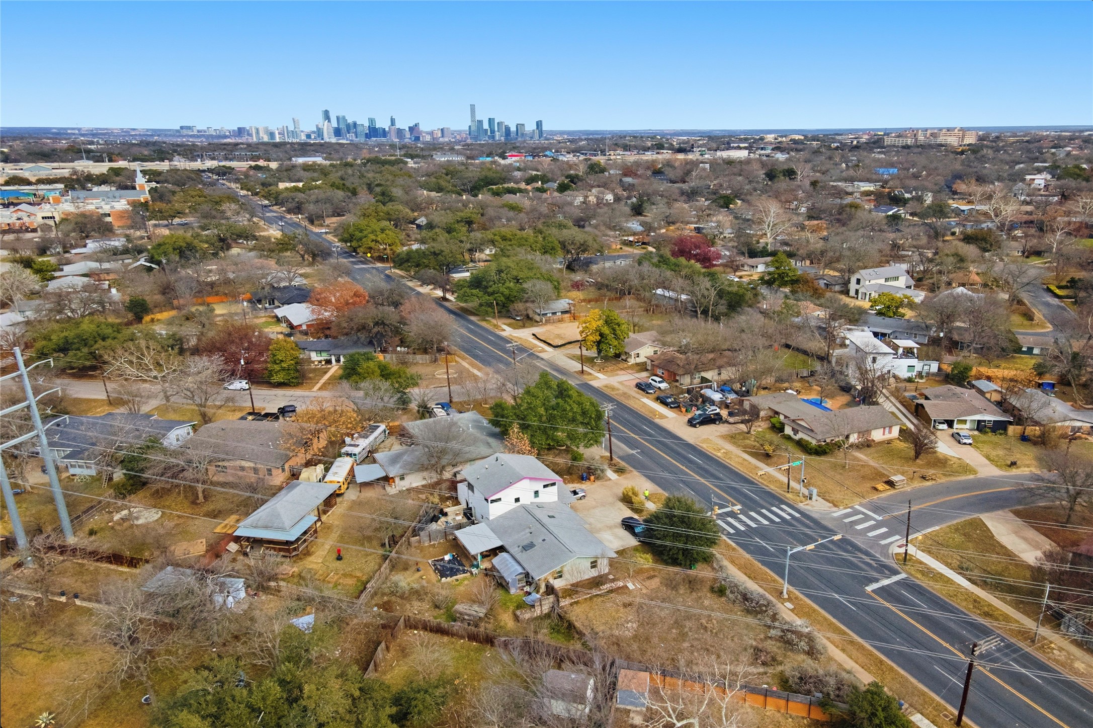 4804 Menchaca Road Austin, TX 78745 - Photo 38 of 38 Aerial view of property and surrounding area with nearby suburban area and skyline