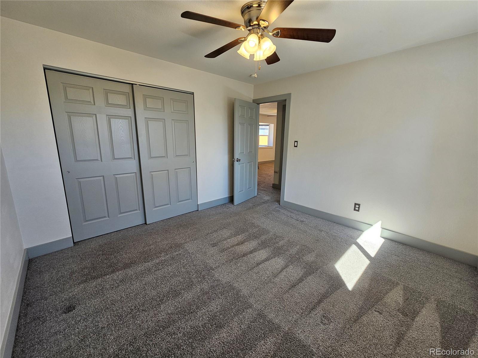 1723 Ascot Road Colorado Springs, CO 80906 - Photo 11 of 29 a view of an empty room and chandelier fan