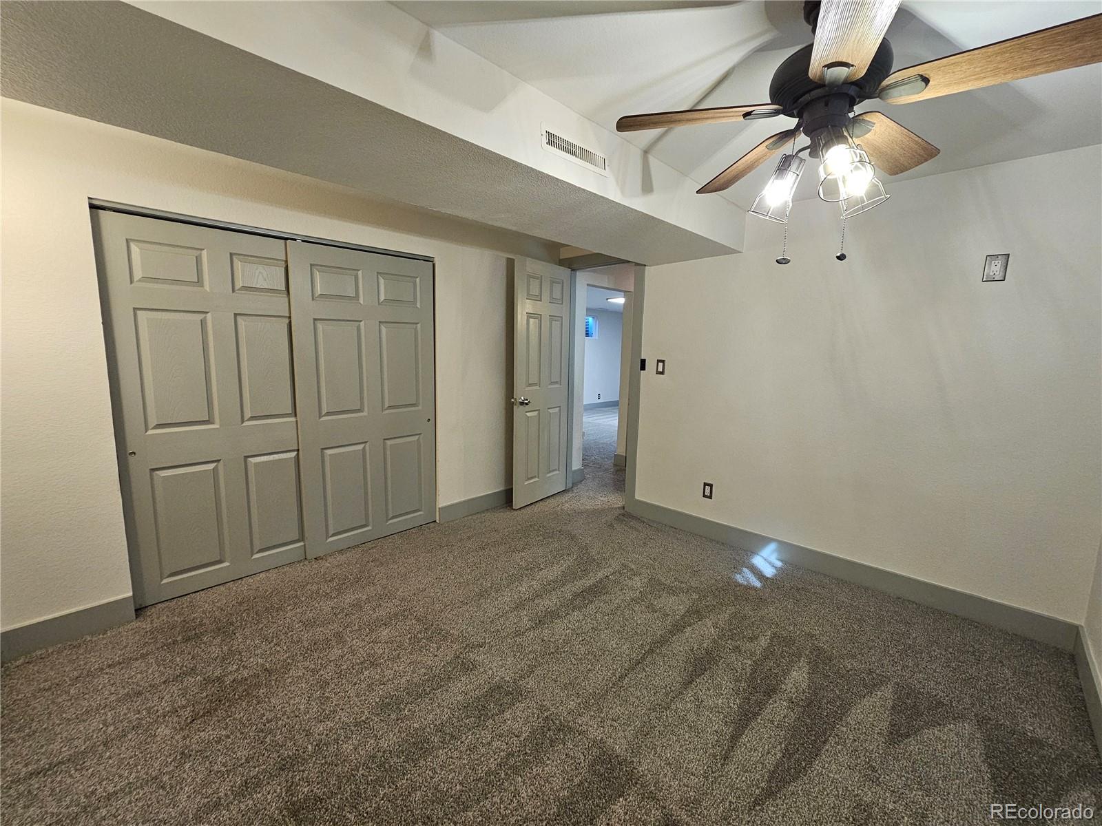 1723 Ascot Road Colorado Springs, CO 80906 - Photo 21 of 29 en empty room with windows and fan