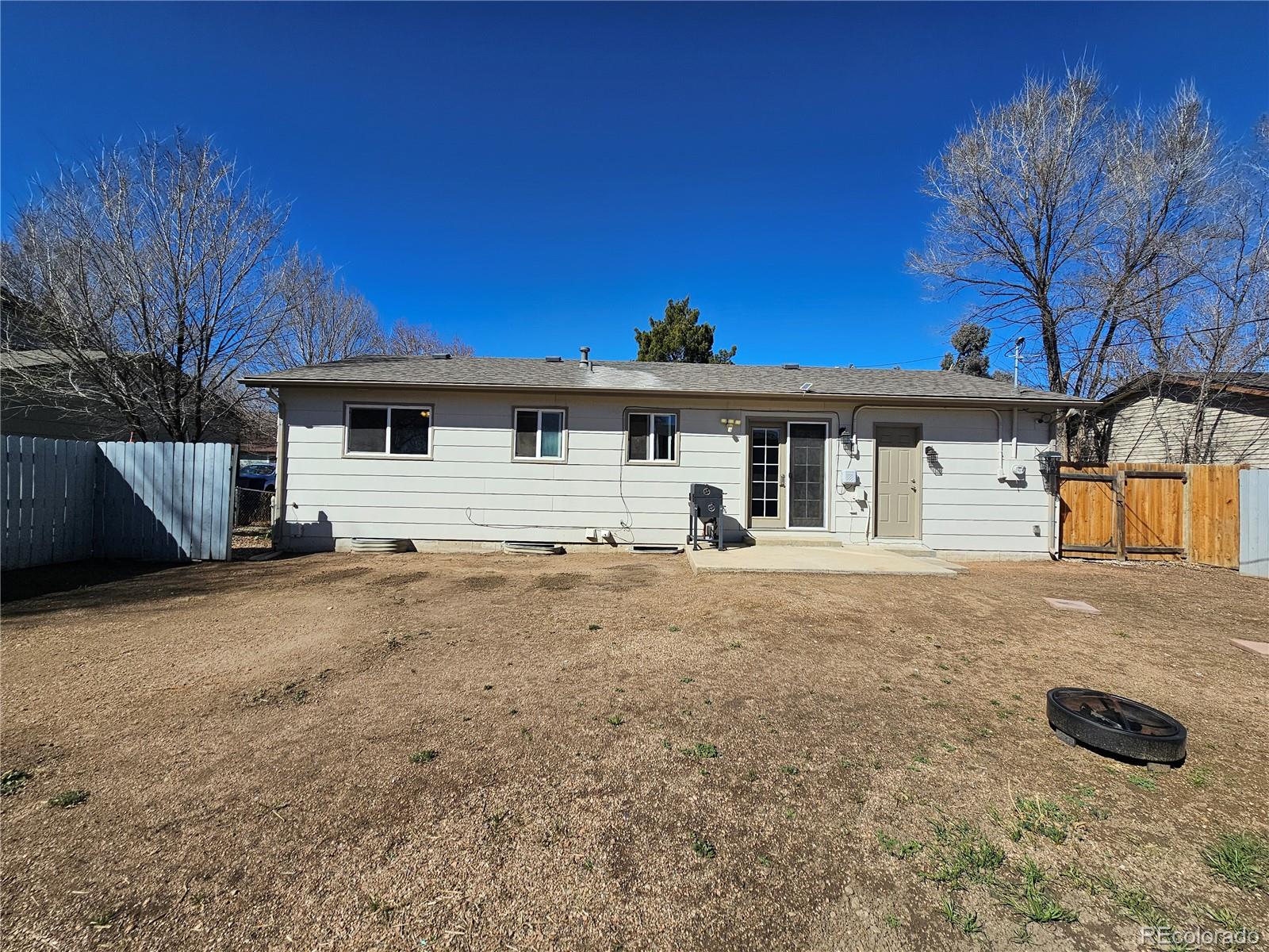 1723 Ascot Road Colorado Springs, CO 80906 - Photo 29 of 29 a front view of a house with a yard and garage