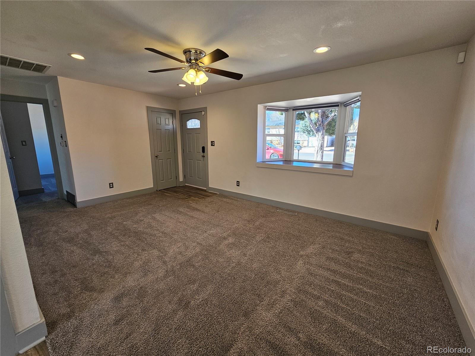 1723 Ascot Road Colorado Springs, CO 80906 - Photo 5 of 29 a view of an empty room with a ceiling fan