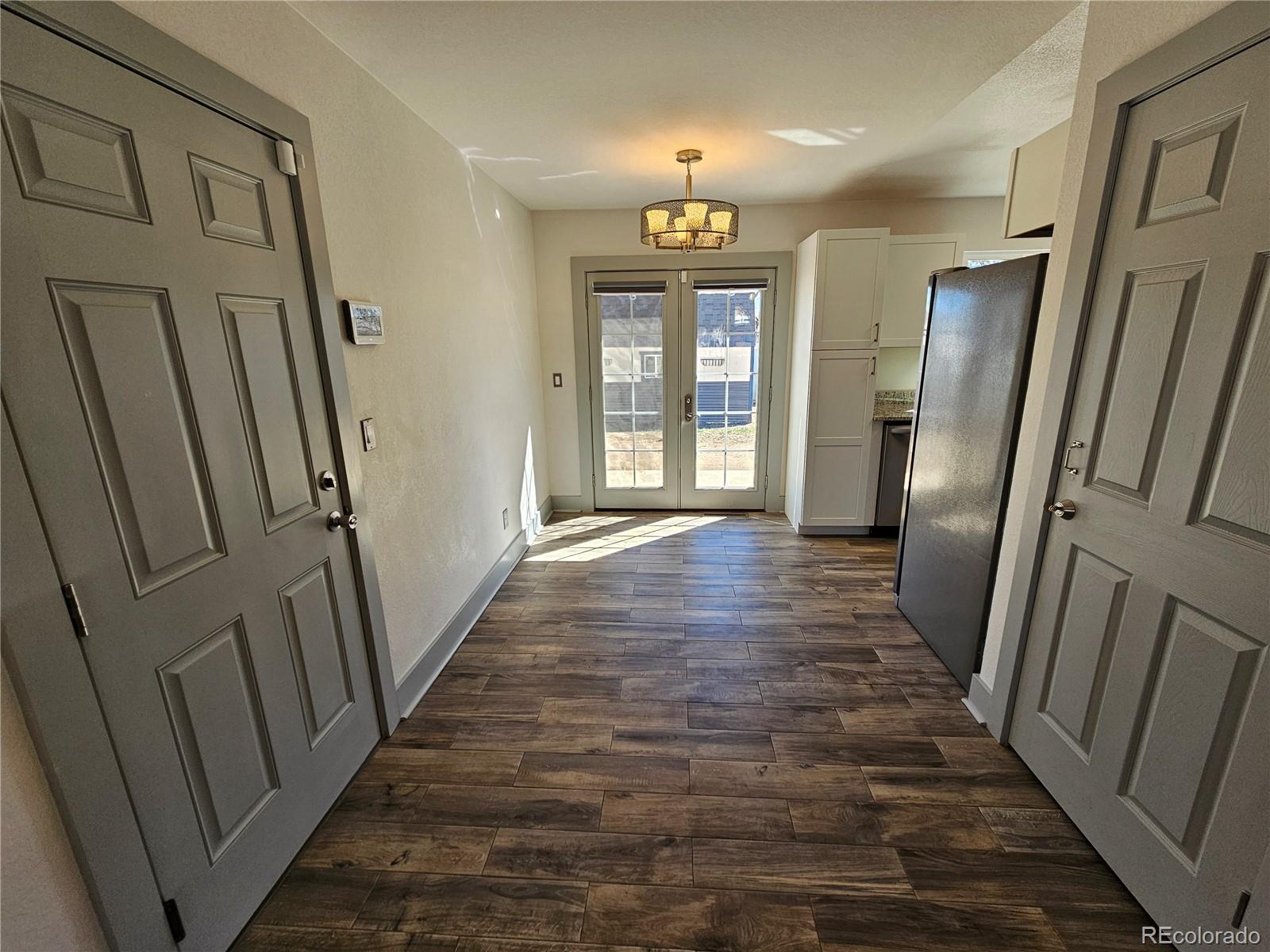 1723 Ascot Road Colorado Springs, CO 80906 - Photo 6 of 29 a view of a hallway with wooden floor and staircase