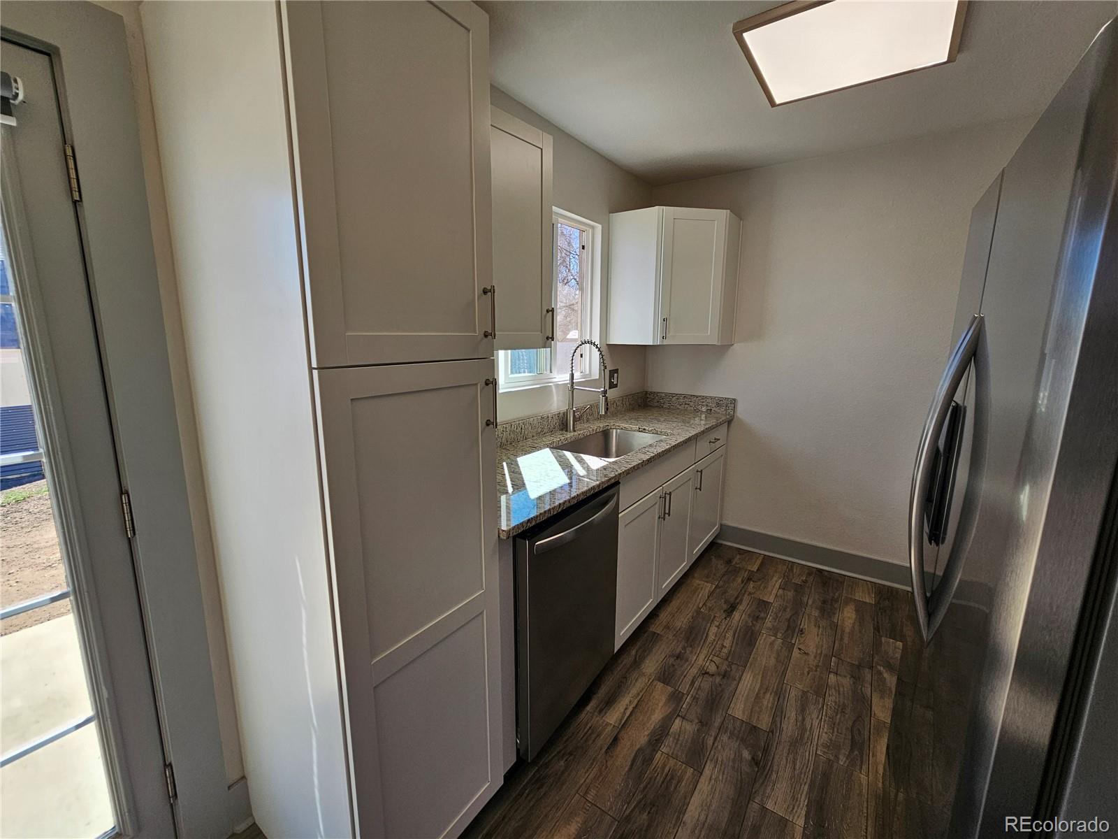 1723 Ascot Road Colorado Springs, CO 80906 - Photo 8 of 29 a kitchen with a refrigerator a sink and dishwasher