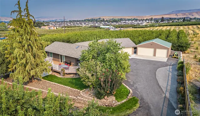 an aerial view of a house with a garden and lake view
