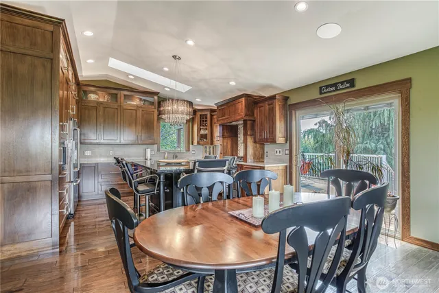 a dining room with furniture window and wooden floor