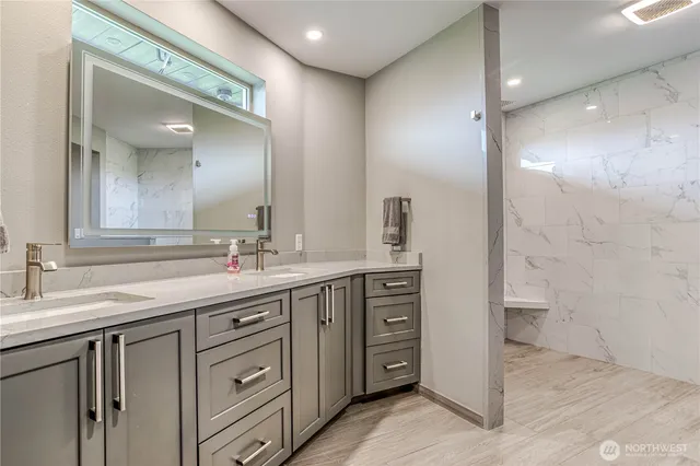 a bathroom with a double vanity sink and a mirror