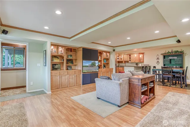a living room with furniture and view of kitchen