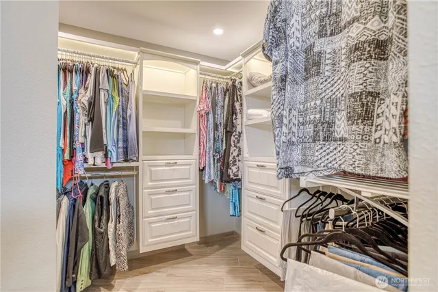 a view of walk in closet with clothes
