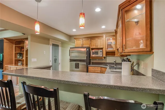 a kitchen with counter top space cabinets and stainless steel appliances