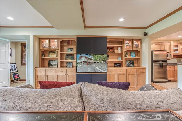 a living room with furniture and a kitchen