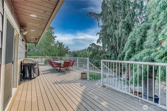 a view of couches on the deck with wooden floor