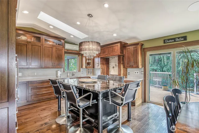 a view of a dining room and livingroom with furniture wooden floor and a rug