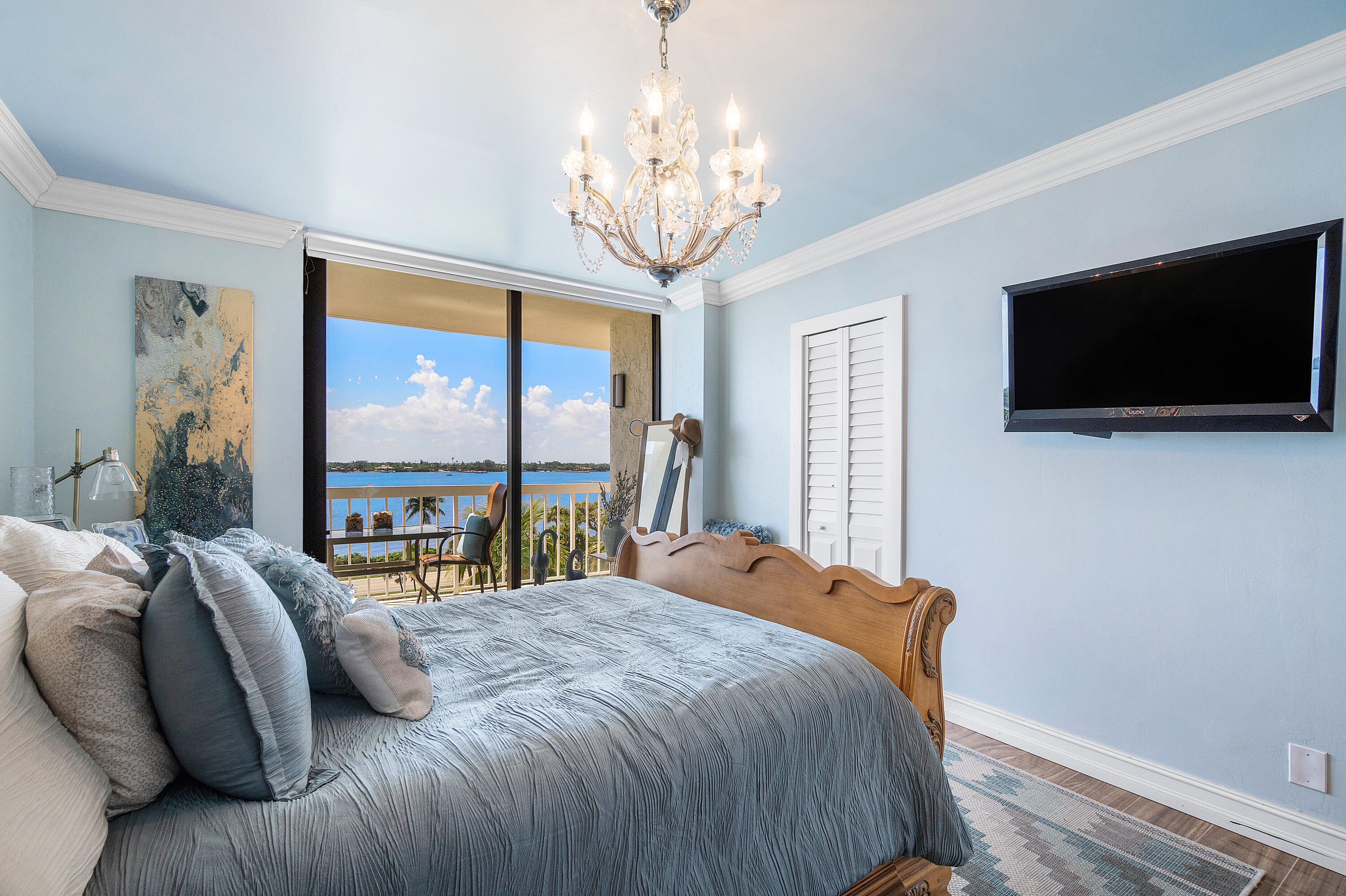 3300 South Ocean Boulevard, Unit 405 Palm Beach, FL 33480 - Photo 13 of 23 a bedroom with a bed and a flat tv screen on the dresser