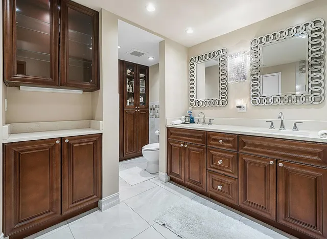 a spacious bathroom with a granite countertop double vanity sink mirror and