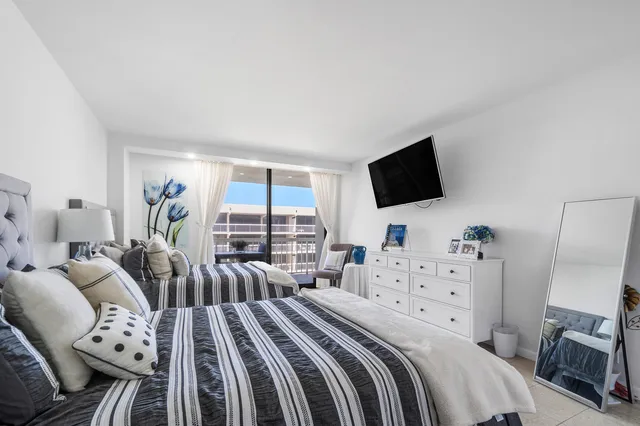 a bedroom with two beds and a flat screen tv