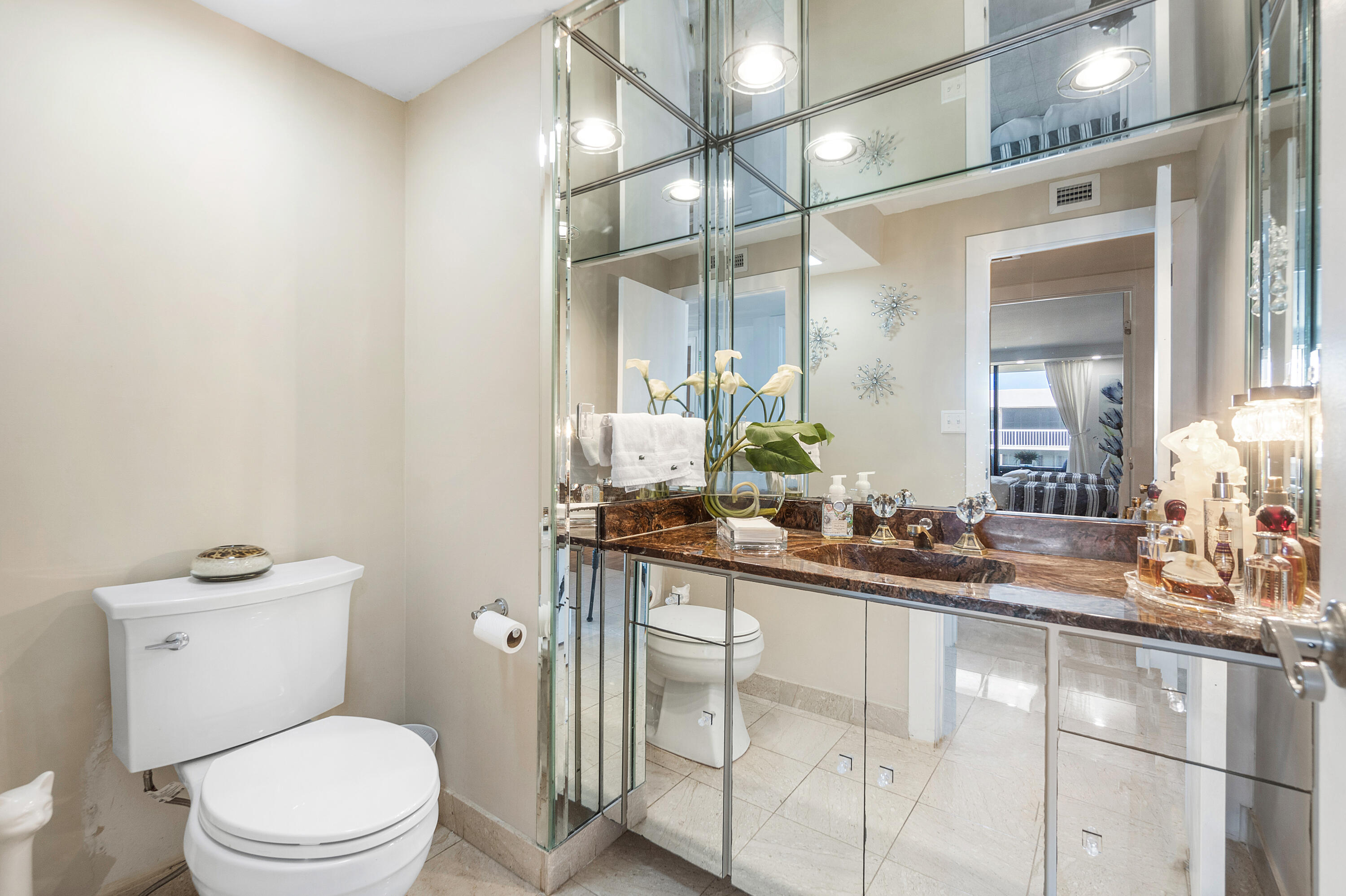 3300 South Ocean Boulevard, Unit 405 Palm Beach, FL 33480 - Photo 17 of 23 a bathroom with a sink a toilet a mirror and vanity