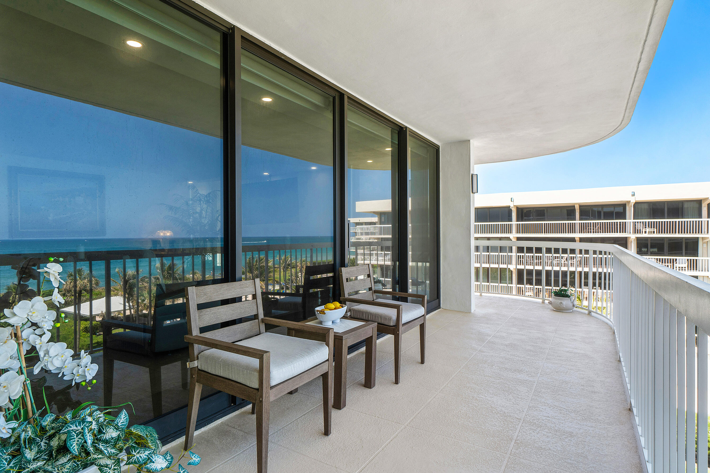 3300 South Ocean Boulevard, Unit 405 Palm Beach, FL 33480 - Photo 21 of 23 a living room with couches a dining table and chairs with outer view