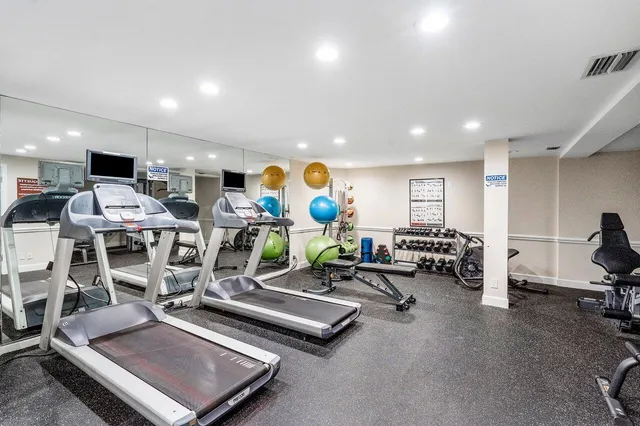 a living room with lots of furniture and gym equipment