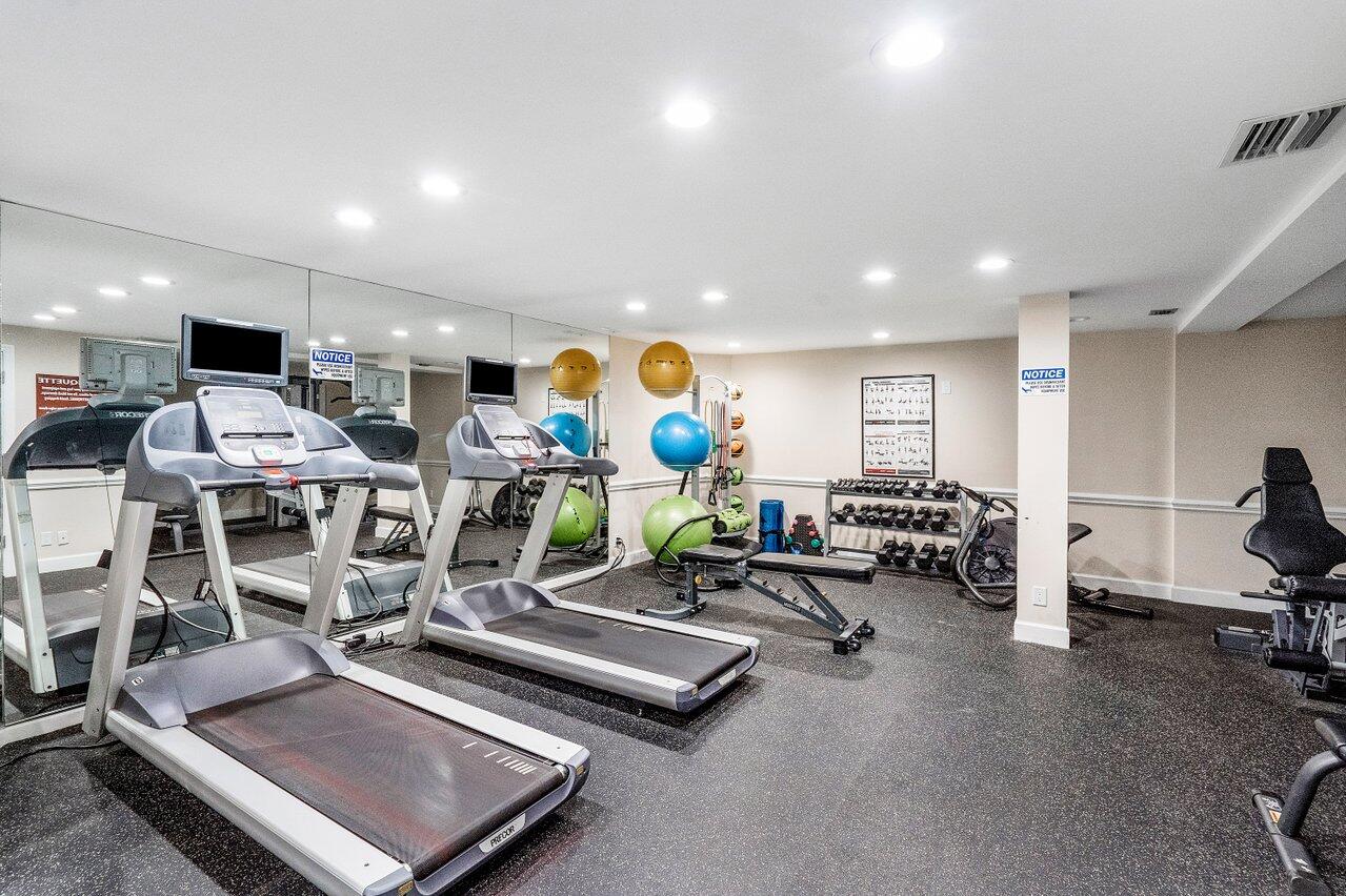 3300 South Ocean Boulevard, Unit 405 Palm Beach, FL 33480 - Photo 22 of 23 a living room with lots of furniture and gym equipment