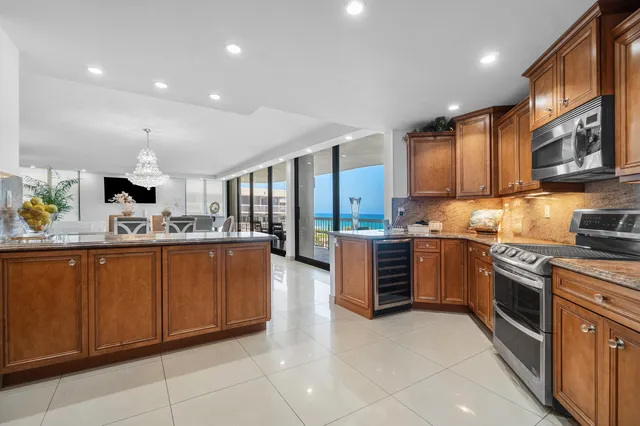 a kitchen with stainless steel appliances granite countertop a stove top oven a sink dishwasher and cabinets