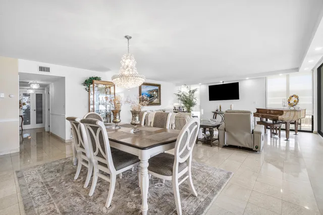 a view of a dining room with furniture and chandelier