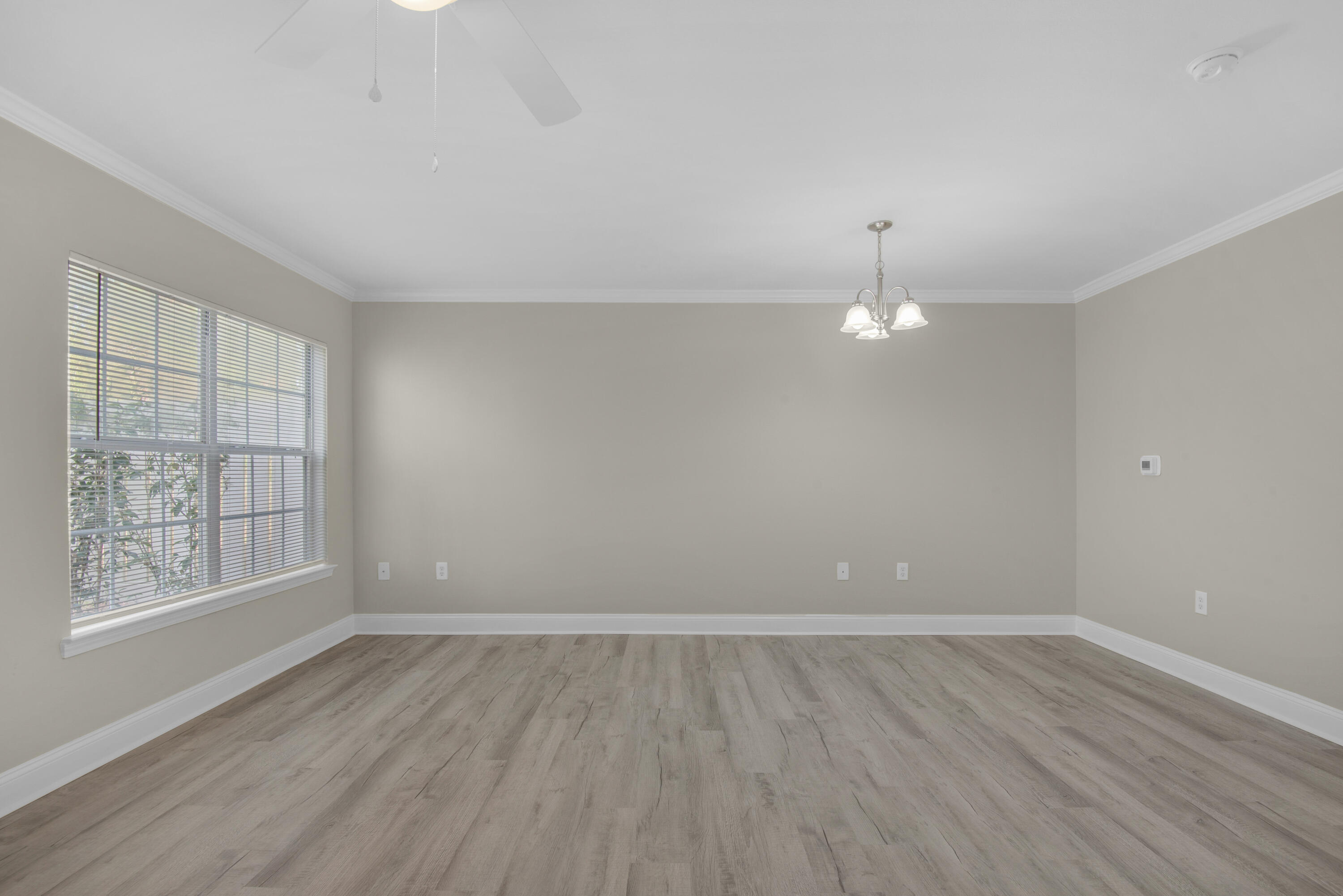537 Wingspan Way Crestview, FL 32536 - Photo 15 of 34 wooden floor in an empty room with a window